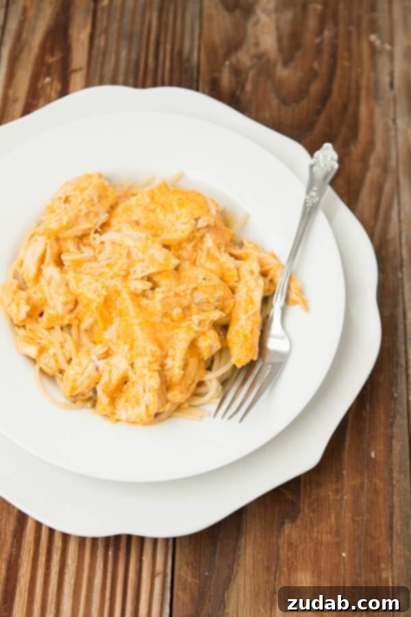 Close-up of baked Angel Hair Chicken Pasta, highlighting the tender chicken and creamy sauce over delicate pasta. Close-up of baked Angel Hair Chicken Pasta, highlighting the tender chicken and creamy sauce over delicate pasta.