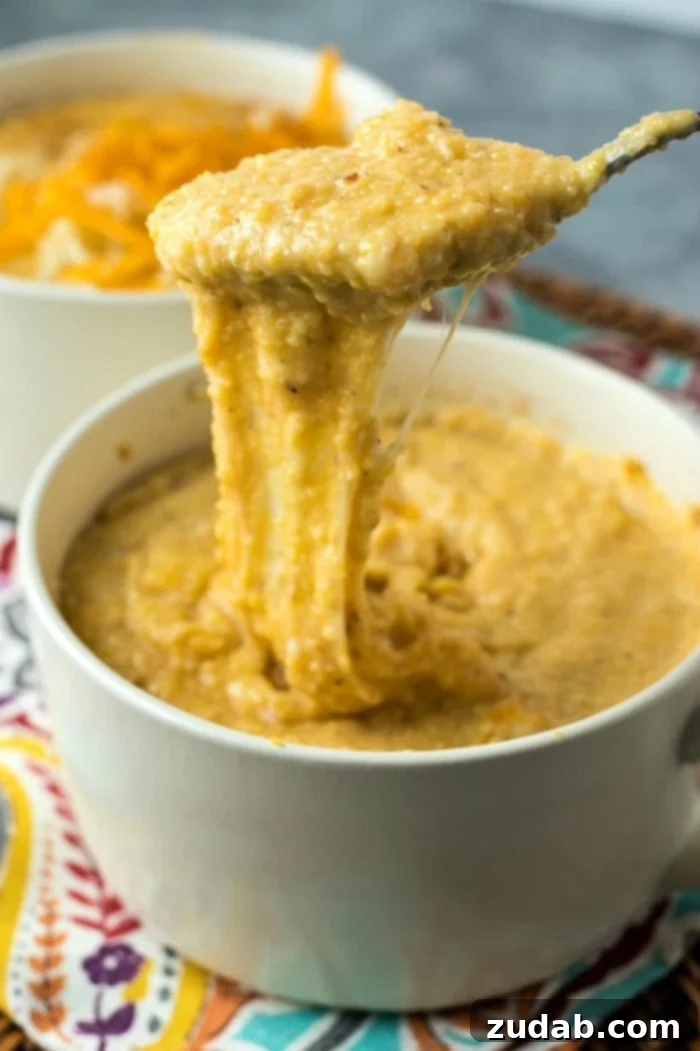 Down Home Cheesy Grits 5 A side view of a bowl of cheesy grits, emphasizing its generous portion and creamy appearance, possibly garnished.