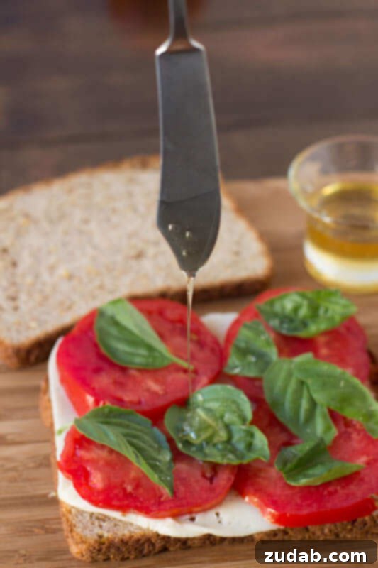Oprah's Favorite Grilled Cheese: Havarti, Tomato, Basil, and a touch of Honey on Whole Wheat Bread A perfectly grilled Havarti Tomato Basil Grilled Cheese with a hint of honey on wholesome whole wheat bread, showcasing the golden crust and melted cheese, ready to eat.