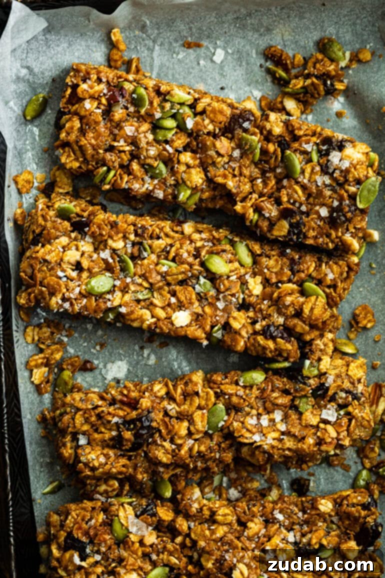 Easy Delicious Cereal Bar Recipe 2 Delicious homemade peanut butter cereal bars arranged neatly on parchment paper, highlighting their chewy texture and wholesome ingredients.