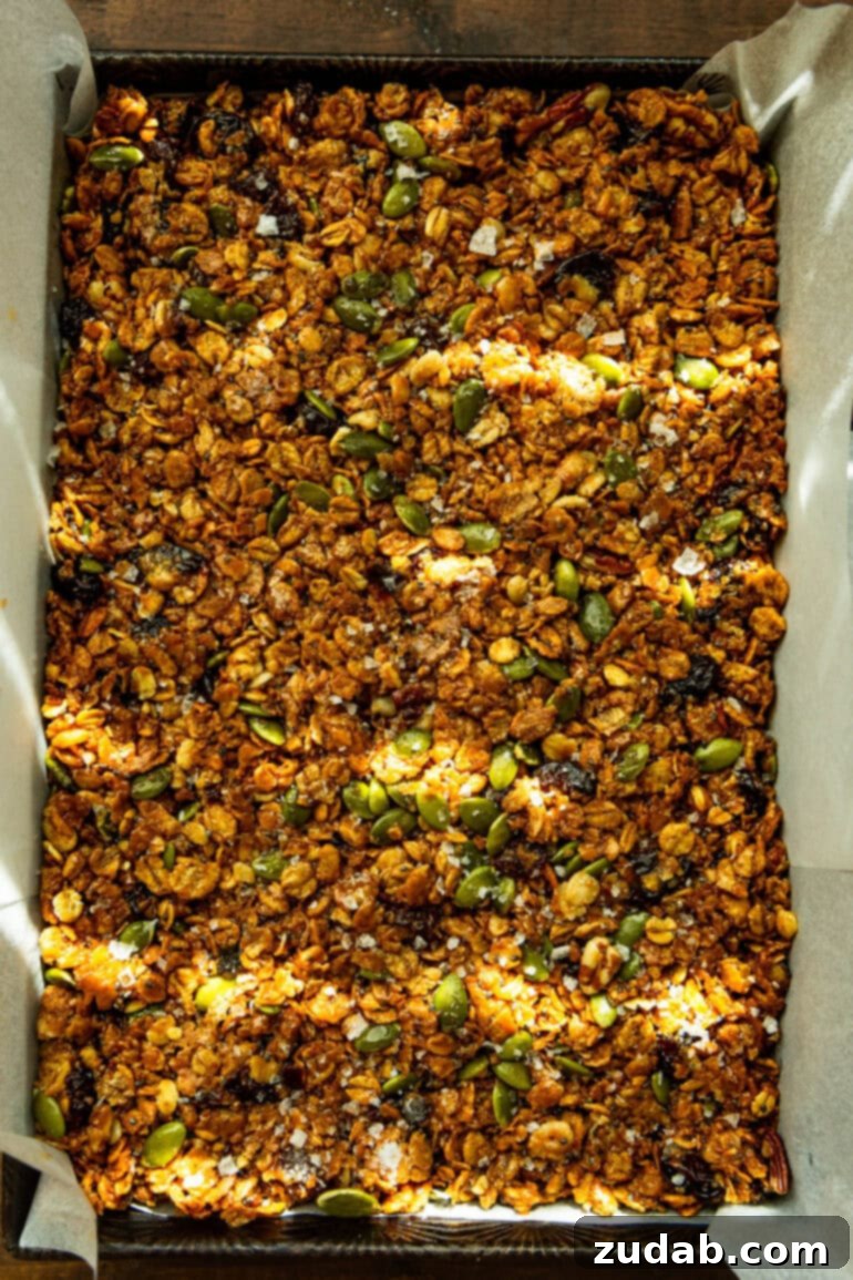 Easy Delicious Cereal Bar Recipe 5 Homemade cereal bars pressed firmly into a 9x13 inch pan, ready for chilling and slicing.