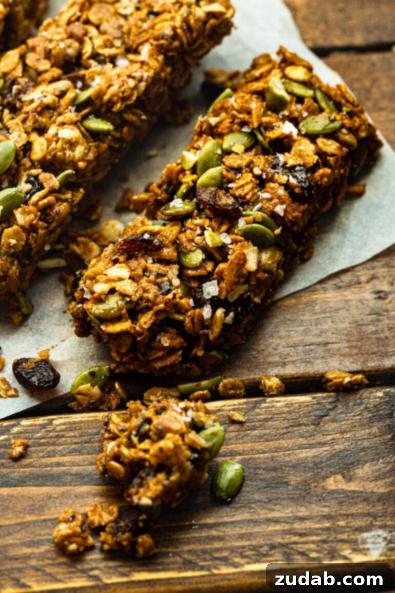 Easy Delicious Cereal Bar Recipe 6 Several chewy oat cereal bars arranged on a rustic wooden table, garnished with flaky sea salt, ready for a healthy snack.