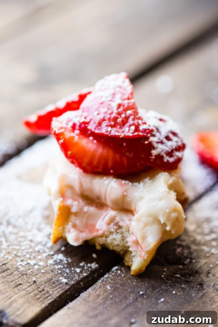 Brown Sugar Kissed Strawberry Crostini 3 A brown board with brown sugar strawberry crostinis and a dash of powdered sugar