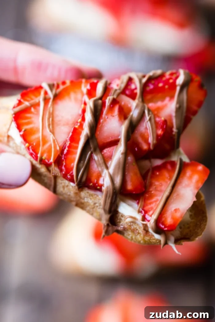 Brown Sugar Kissed Strawberry Crostini 5 A brown board with brown sugar strawberry crostinis and a chocolate drizzle
