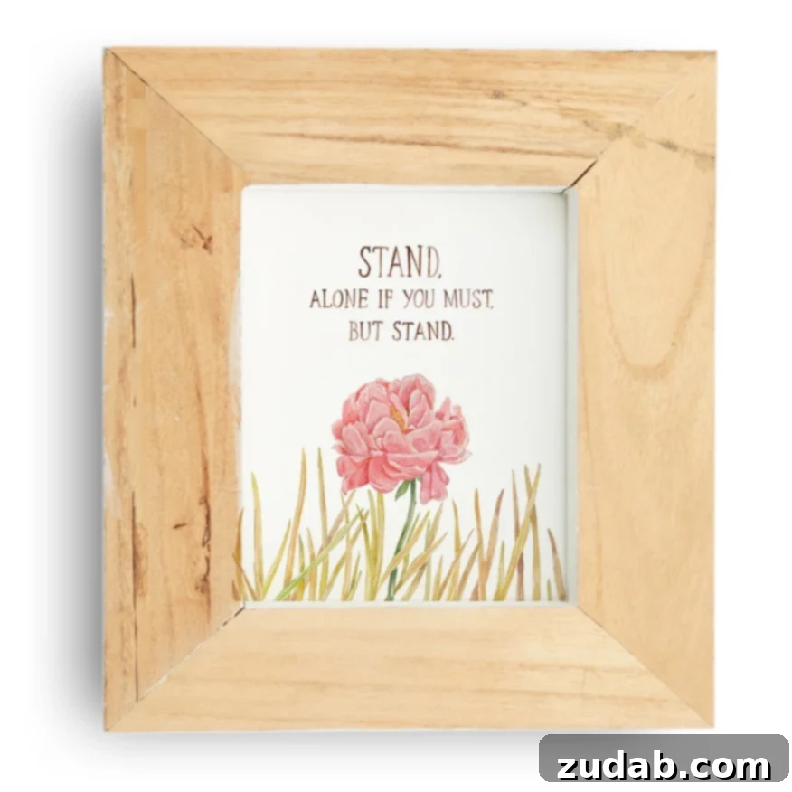 A vibrant pink peony stands tall amidst dry, brittle weeds, symbolizing strength and conviction in challenging environments, with the inspirational motto: Stand, alone if you must, but stand.