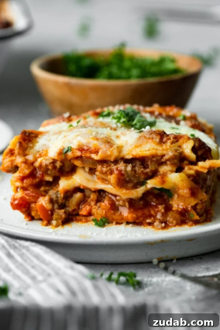 My Go-To Lasagna Masterpiece 2 A generously portioned serving of layered hearty meat lasagna on a pristine white plate, adorned with glistening melted cheese and a sprinkle of fresh chopped parsley. The layers are perfectly defined, showcasing the rich sauces and cheeses.