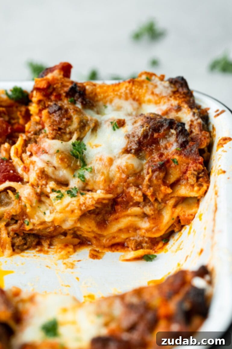 My Go-To Lasagna Masterpiece 10 A delicious serving of homemade meat lasagna sits in a baking dish, showcasing its thick, comforting layers of pasta, meat sauce, and melted cheese, ready to be enjoyed.