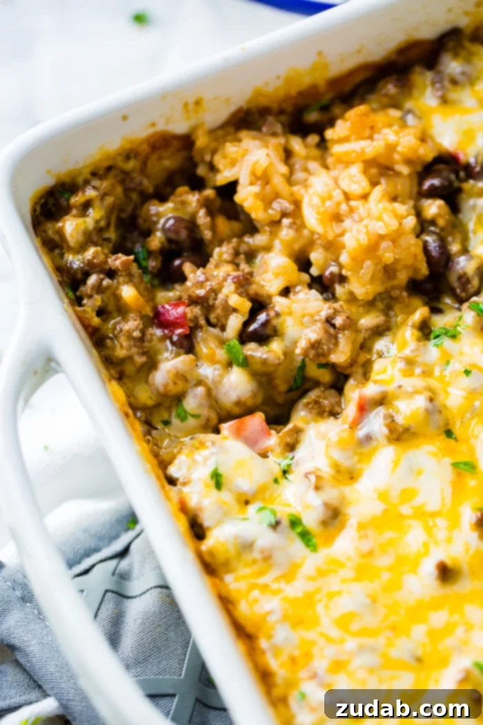Zesty Beef and Rice Cheese Bake 3 A top-down view of a white casserole dish showcasing a delicious Mexican ground beef casserole ready to be served.