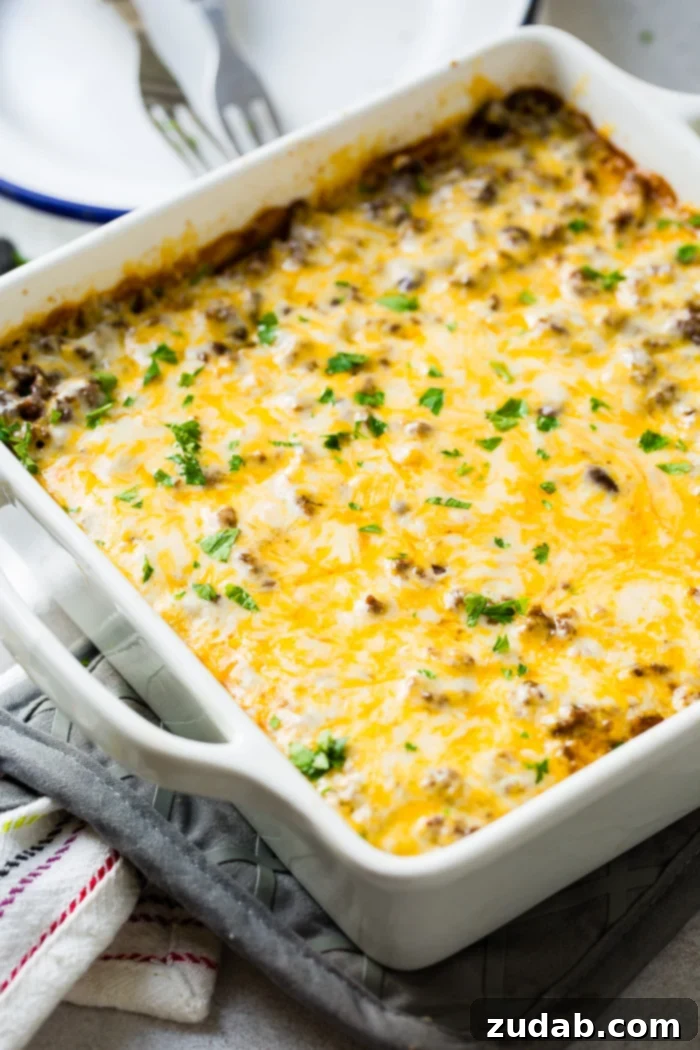 Zesty Beef and Rice Cheese Bake 4 A white casserole dish filled with a vibrant Mexican ground beef casserole, garnished with fresh toppings.