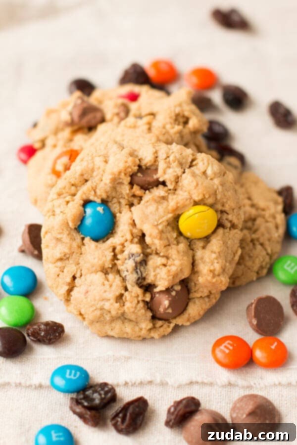 You won't be able to stop eating these Monster Cookies! Peanut butter, M&M's, and chocolate are a perfect combo! A close-up of delicious Monster Cookies, showcasing their delightful mix of M&M's and chocolate chips.