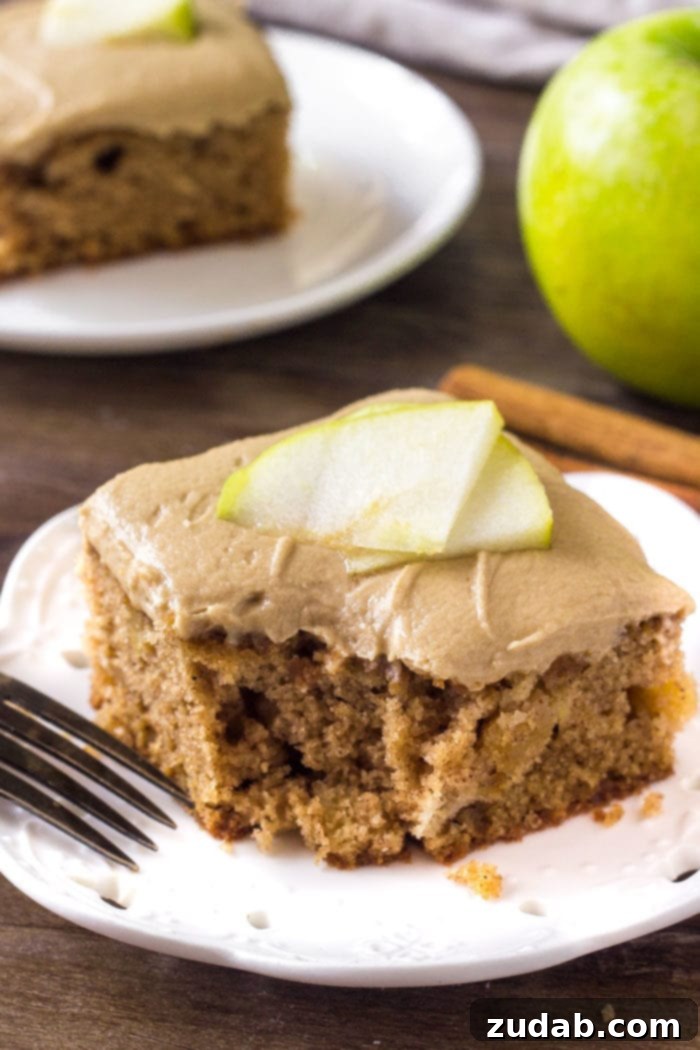 Decadent Caramel Apple Cake 5 A slice of apple spice cake with caramel frosting.