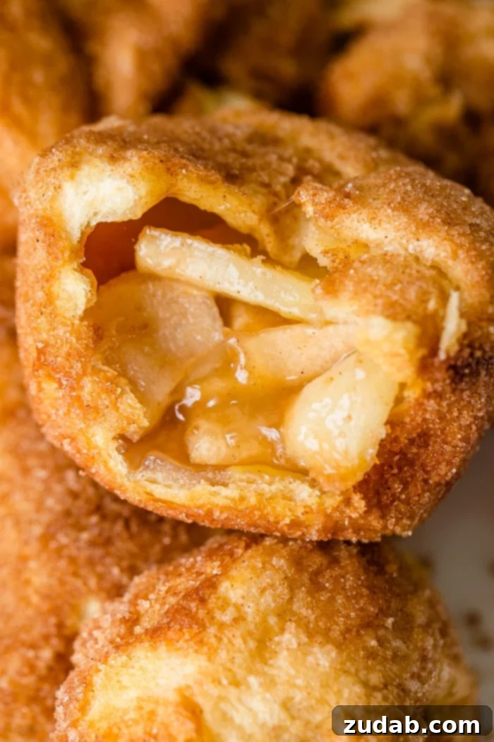 Apple Empty Tomb Rolls 2 Close-up of a freshly baked Apple Empty Tomb Roll, showcasing its golden crust and delicious apple-caramel filling