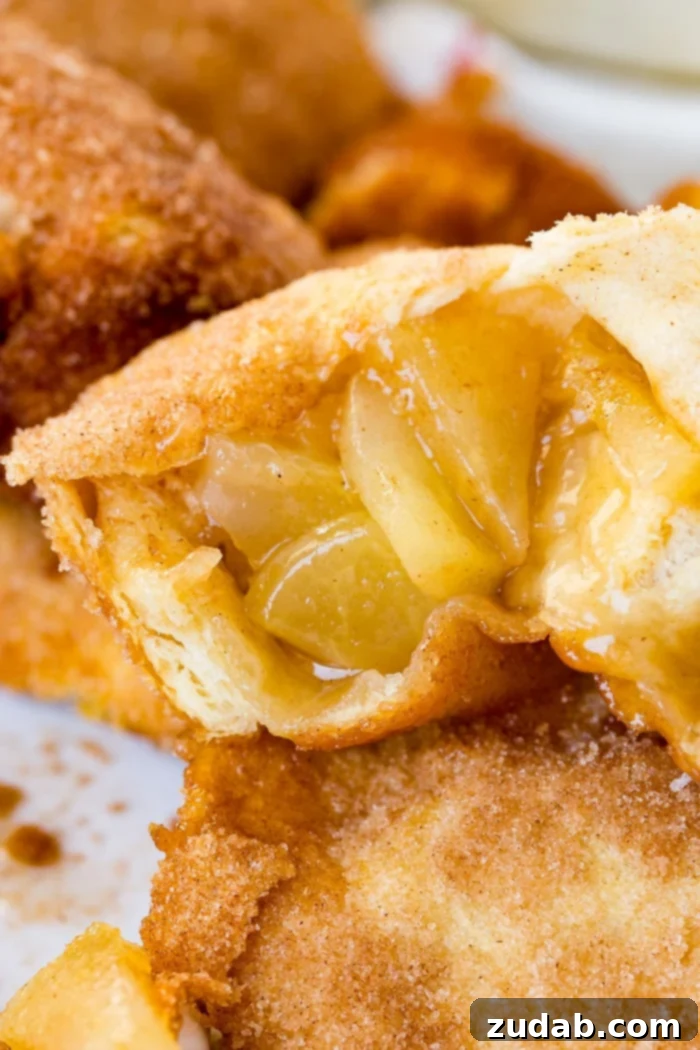 Apple Empty Tomb Rolls 4 Beautifully arranged Apple Empty Tomb Rolls on a cooling rack, glistening with caramel