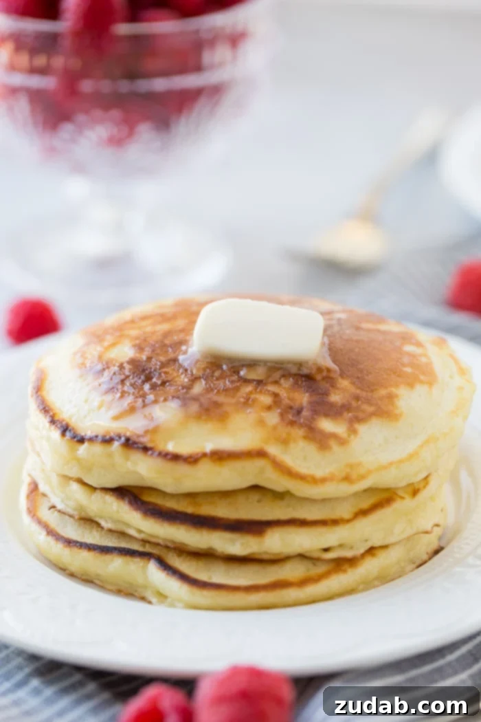 Cloud-Like Sour Cream Pancakes 4 A stack of fluffy homemade sour cream pancakes with a little butter melting on top and a drizzle of syrup dripping down the side. Our recipe for melt in your mouth sour cream pancakes