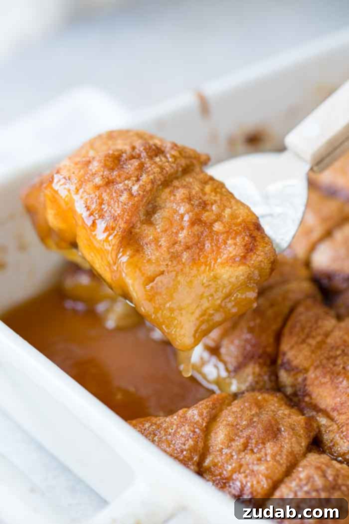 Sparkling Sprite Apple Dumplings 5 A full white casserole dish of baked apple dumplings, with some sauce visible around the edges.