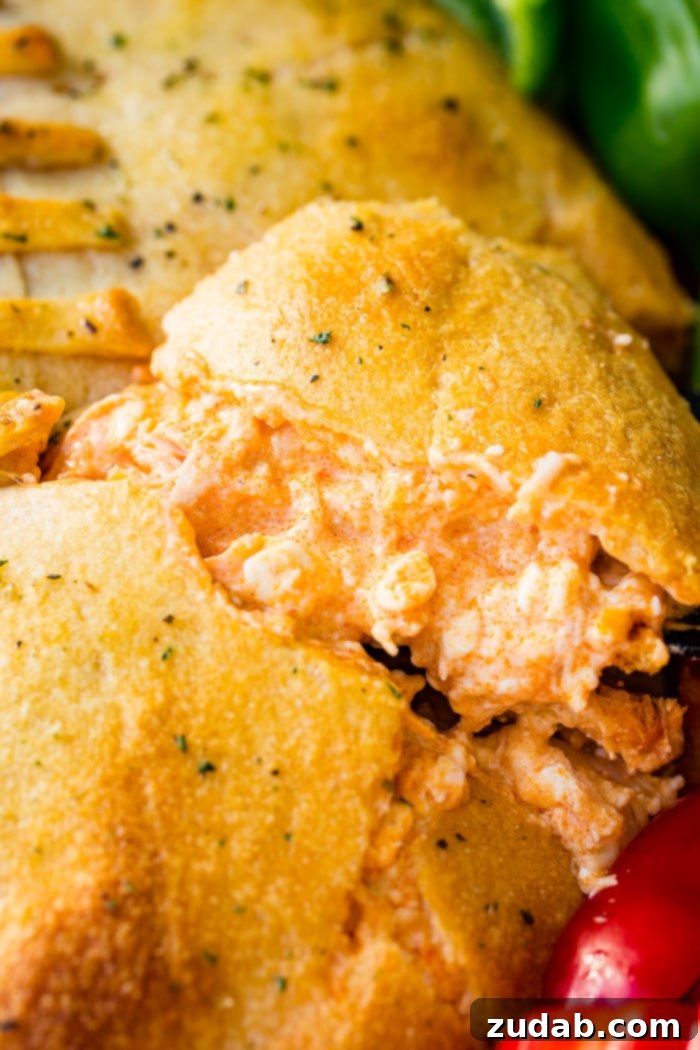 Touchdown Buffalo Chicken Dip 6 A cookie sheet with crackers, celery, peppers, and a football made out of crescent rolls and stuffed with buffalo chicken dip recipe