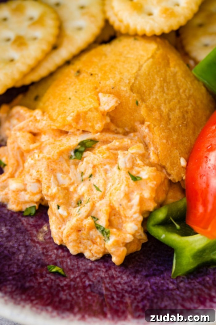 Touchdown Buffalo Chicken Dip 7 A cookie sheet with crackers, celery, peppers, and a football made out of crescent rolls and stuffed with buffalo chicken dip recipe