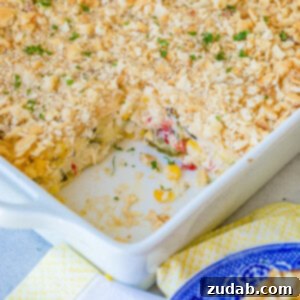 Golden Zucchini Corn Gratin 7 A top-down view of the Cheesy Zucchini Corn Casserole in a square baking dish, ready to be served.