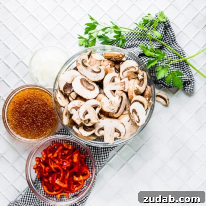 Delicious Italian Sauteed Mushrooms 4 Ingredients for making easy and quick Italian Sauteed Mushrooms, neatly arranged on a cutting board, including fresh baby bella mushrooms, a red bell pepper, an onion, and a bottle of Italian dressing.