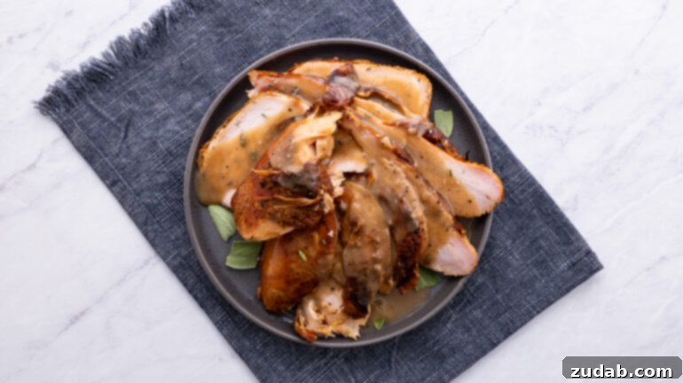 An overhead view of a beautifully sliced smoked turkey, showcasing its juicy texture and golden-brown skin.
