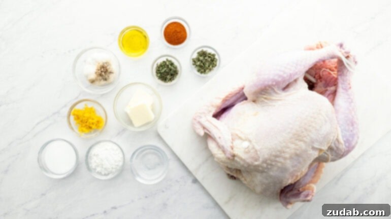 A raw whole turkey rests on a wooden cutting board, surrounded by small white ramekins filled with fresh herbs, lemon zest, and softened butter, ready for the herb butter rub.