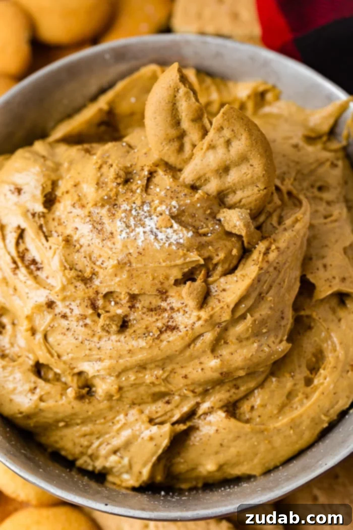 Creamy Gingerbread Delight 2 a silver bowl full of fluffy gingerbread cookie dip or molasses cookie dip with graham crackers and nilla wafers
