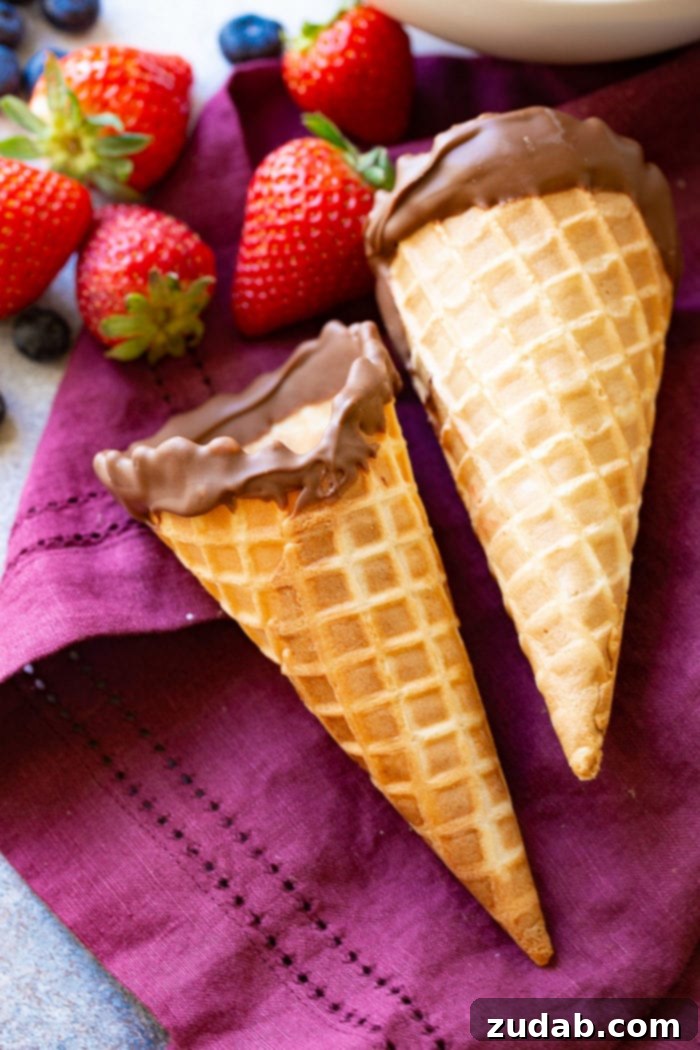 Waffle Cone Fruit Yogurt Parfaits 6 2 waffle cones dipped in chocolate with berries on a purple linen.
