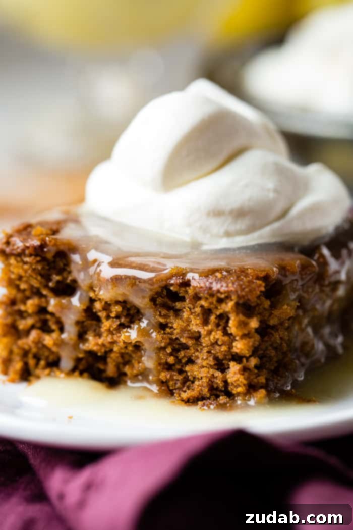 Spiced Ginger Cake with Zesty Lemon Glaze 2 A glistening slice of warm gingerbread cake topped with a bright lemon sauce and a swirl of freshly whipped cream, capturing the essence of holiday traditions.