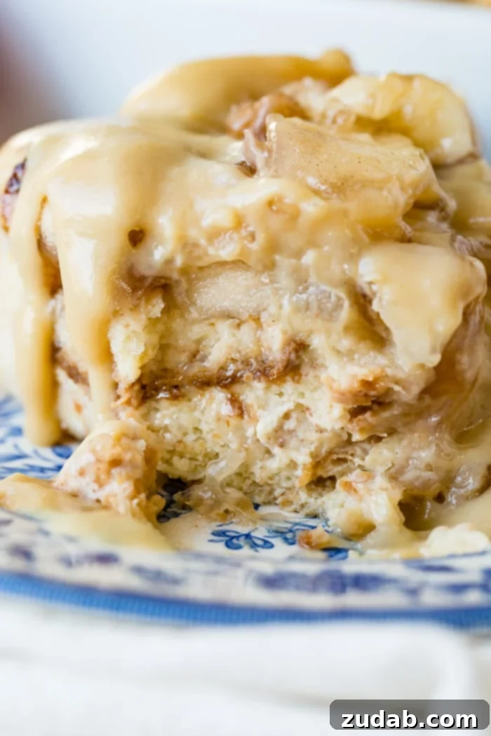Warm Apple Pie Bread Pudding Drizzled with Vanilla Sauce 2 Apple Bread Pudding with Vanilla Sauce on blue and white china plate