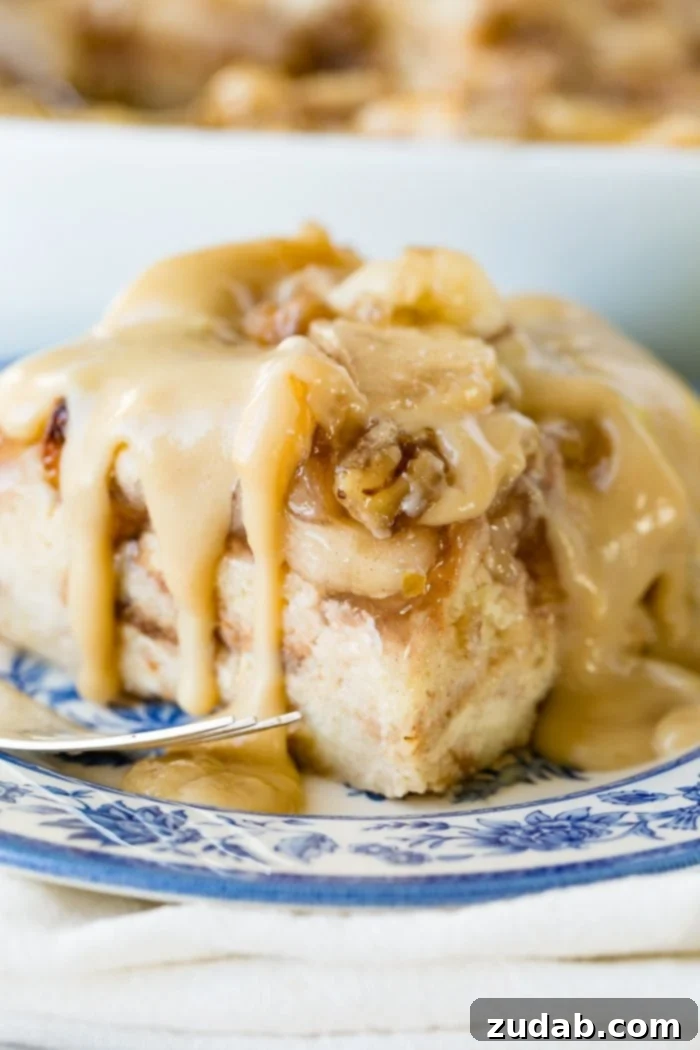 Warm Apple Pie Bread Pudding Drizzled with Vanilla Sauce 3 a large slice of apple bread pudding with vanilla sauce sitting on a blue china plate