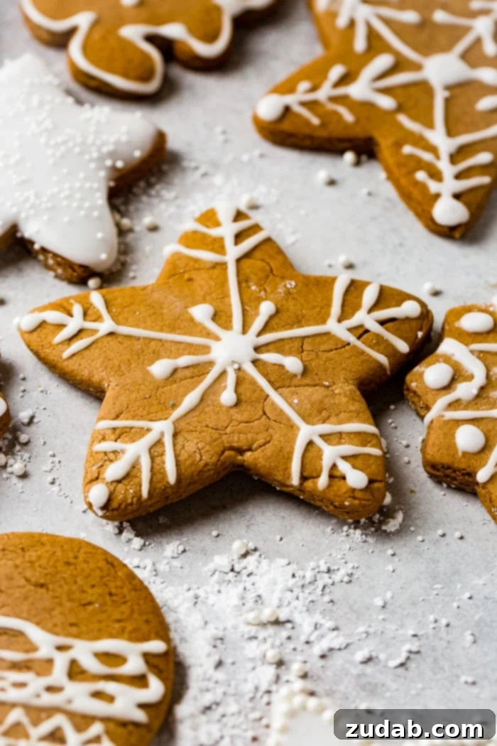 Perfectly Soft Gingerbread Cookies Recipe 3 a grey board with the best soft gingerbread cookies recipe decorated with royal icing.