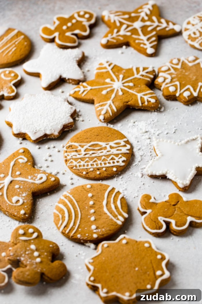 Perfectly Soft Gingerbread Cookies Recipe 5 a grey board with the best soft gingerbread cookies recipe decorated with royal icing.