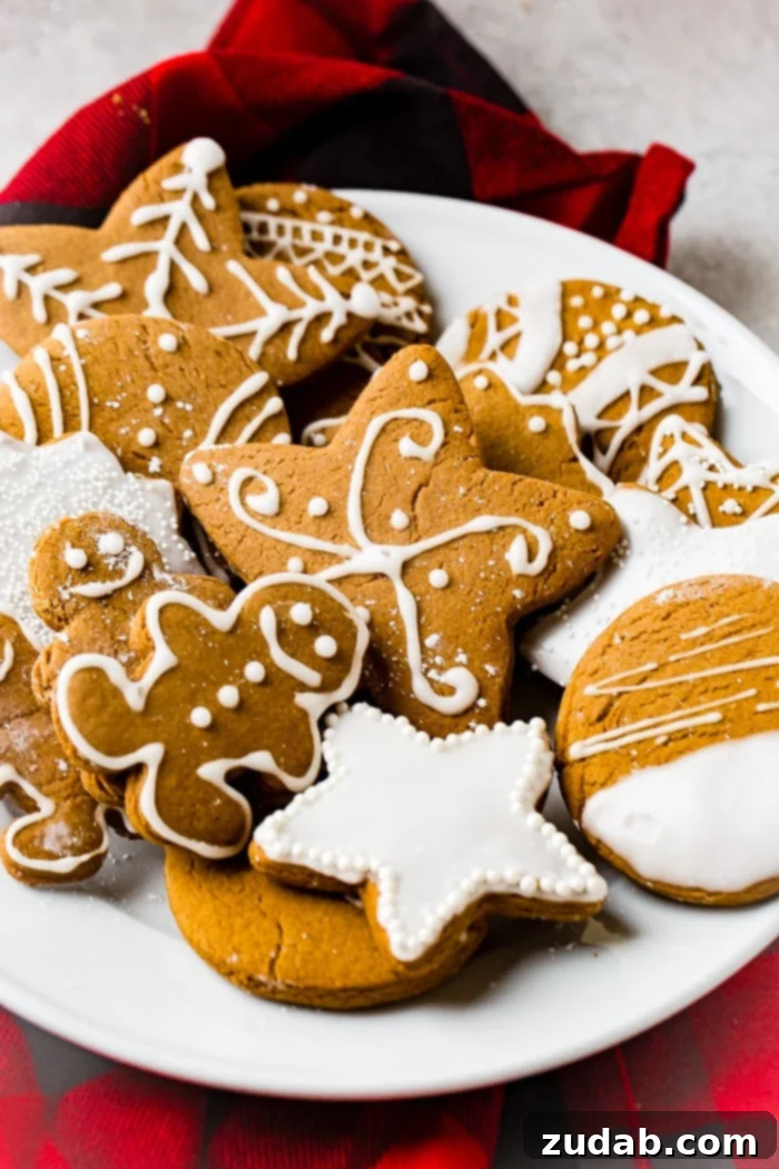 Perfectly Soft Gingerbread Cookies Recipe 6 a grey board with the best soft gingerbread cookies recipe decorated with royal icing.