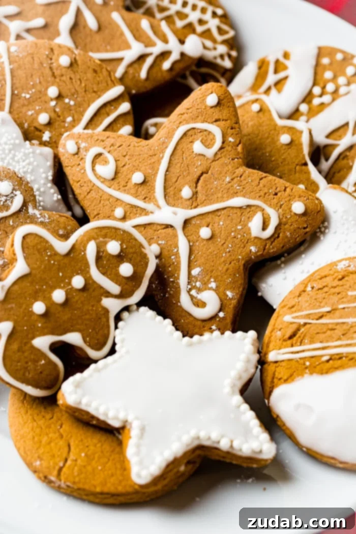 Perfectly Soft Gingerbread Cookies Recipe 7 a grey board with the best soft gingerbread cookies recipe decorated with royal icing.