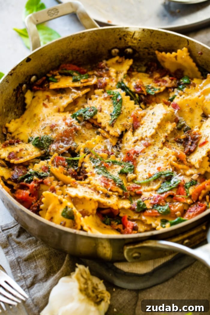 Crispy Pancetta Ravioli: Sun-Kissed Tomato & Spinach Delight 2 A vibrant skillet filled with golden crispy pancetta ravioli, bright sun-dried tomatoes, and fresh green spinach, ready to be served.