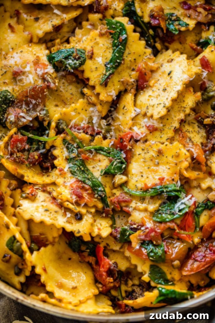 Crispy Pancetta Ravioli: Sun-Kissed Tomato & Spinach Delight 3 Close-up of a rustic skillet showcasing golden brown crispy pancetta, plump cheese ravioli, and colorful sun-dried and grape tomatoes with wilted spinach.