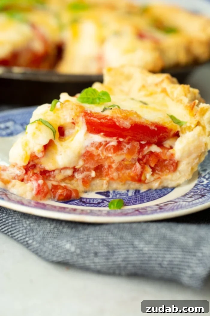 Southern Comfort in a Crust Tomato Pie 2 a slice of southern tomato pie on a blue china plate