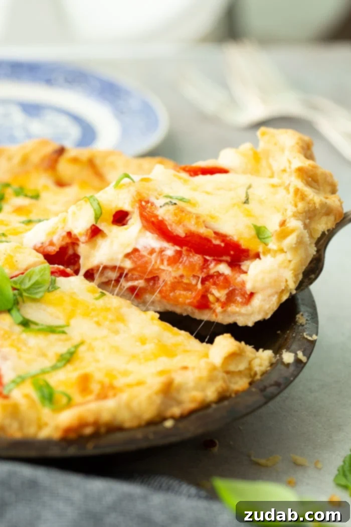 Southern Comfort in a Crust Tomato Pie 3 a slice of southern tomato pie on a blue china plate