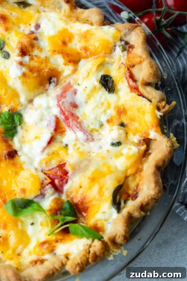 Southern Comfort in a Crust Tomato Pie 4 a photo of a cheesy southern tomato pie in a glass baking dish