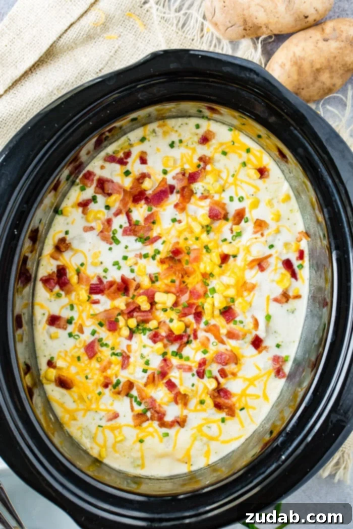 Creamy Slow Cooker Potato, Broccoli & Corn Chowder with Crispy Bacon 3 A bowl of slow cooker potato broccoli corn chowder with bacon, garnished with chives.