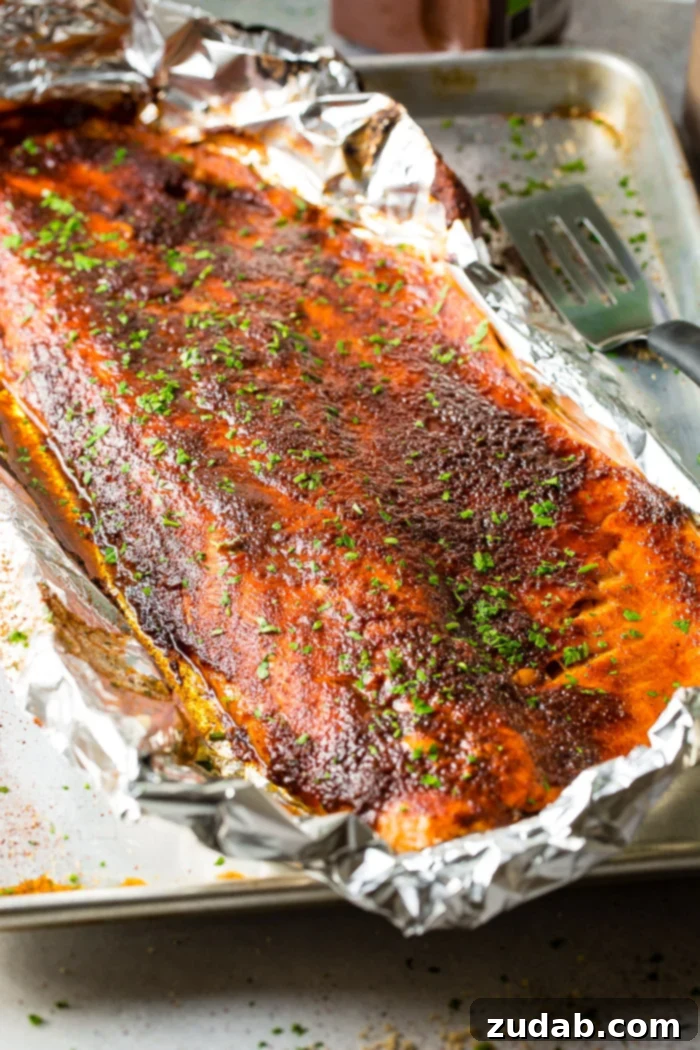 maple salmon in foil on a baking sheet