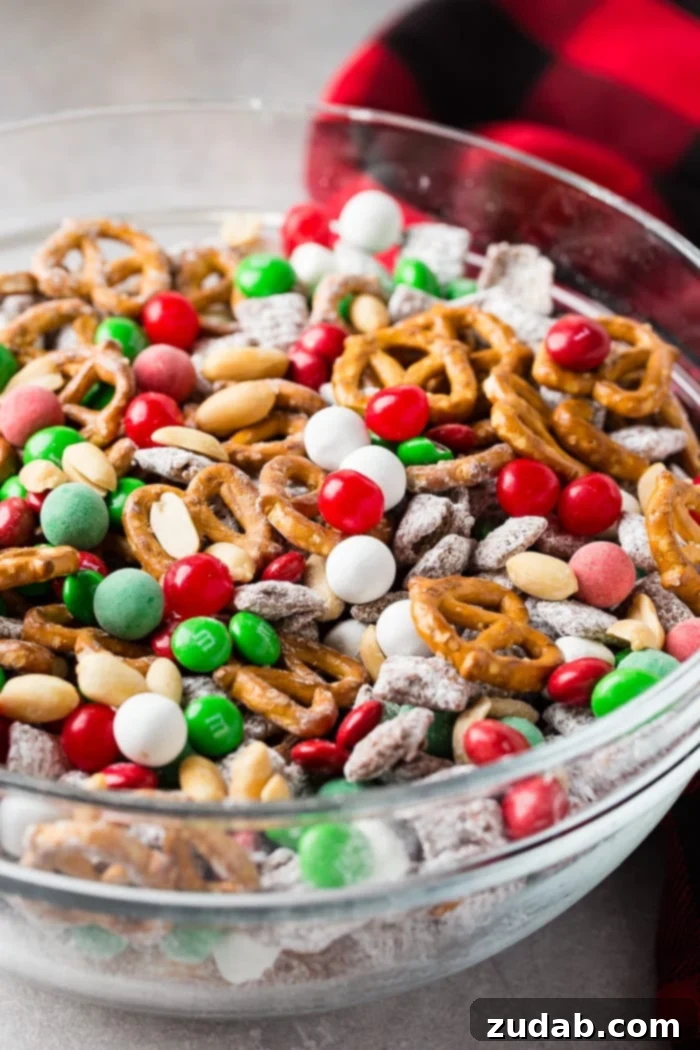 Jolly 5 Minute Christmas Crunch 4 A large glass bowl filled with the colorful and irresistible 5-Minute Christmas Snack Mix, ready to be enjoyed.