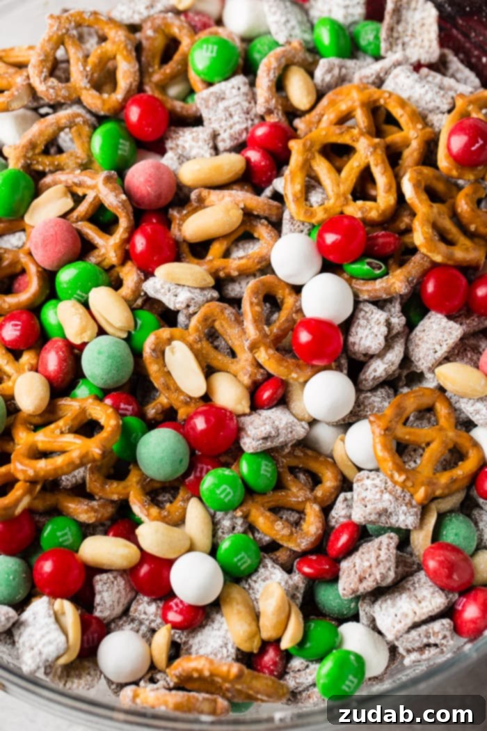 Jolly 5 Minute Christmas Crunch 5 A close-up shot of the irresistible 5-Minute Christmas Snack Mix in a glass bowl, highlighting the textures and vibrant colors of the ingredients.