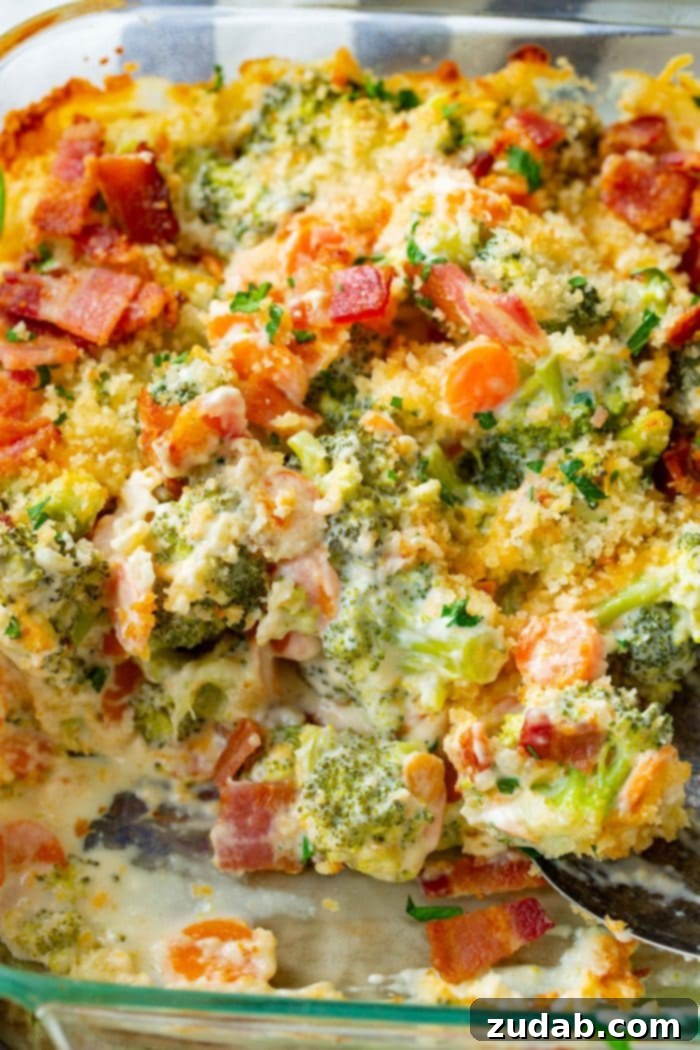 Ultimate Cheesy Bacon Broccoli Bake 3 A close-up shot of a cheesy broccoli casserole in a baking dish, generously topped with crispy bacon bits and golden panko bread crumbs, promising a delightful texture.