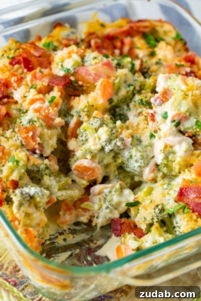 Ultimate Cheesy Bacon Broccoli Bake 5 A glass baking dish filled with creamy cheesy broccoli casserole, generously sprinkled with golden panko bread crumbs and crisp bacon pieces, showcasing its mouth-watering appeal.