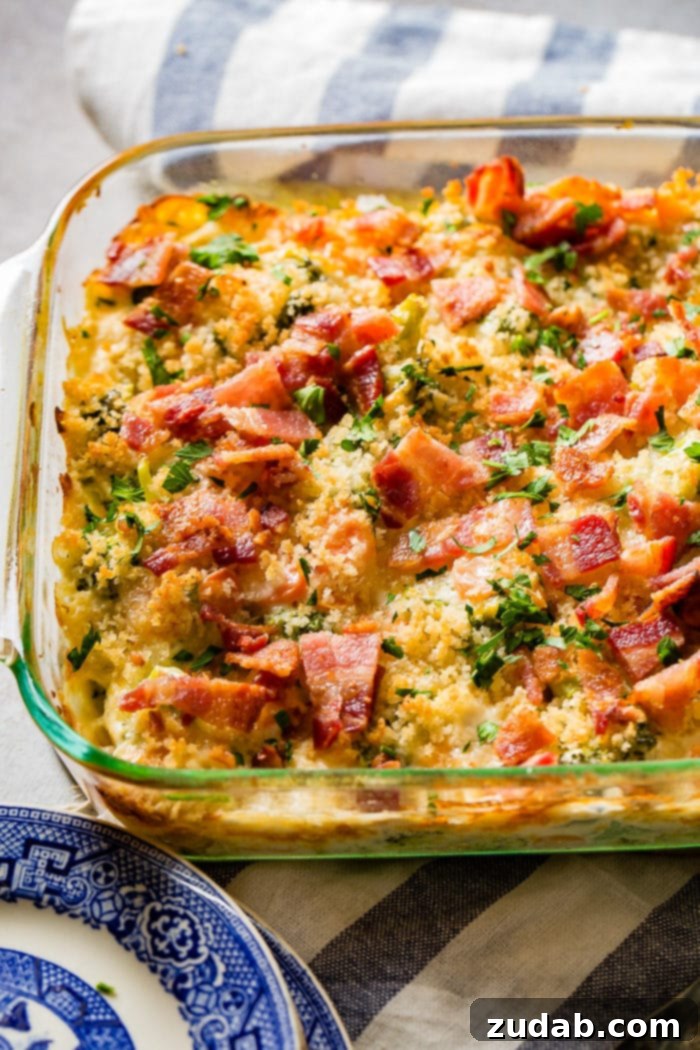 Ultimate Cheesy Bacon Broccoli Bake 7 A baking dish of creamy cheesy broccoli casserole with a golden-brown panko and bacon topping, inviting you to dig in.