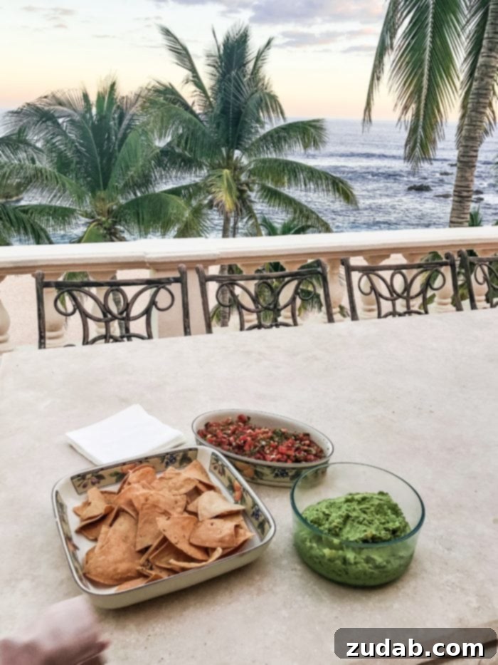 Unlock Mexico's Best Stays 8 Freshly made chips, guacamole, and salsa served on a patio with a stunning view of palm trees and the Sea of Cortez