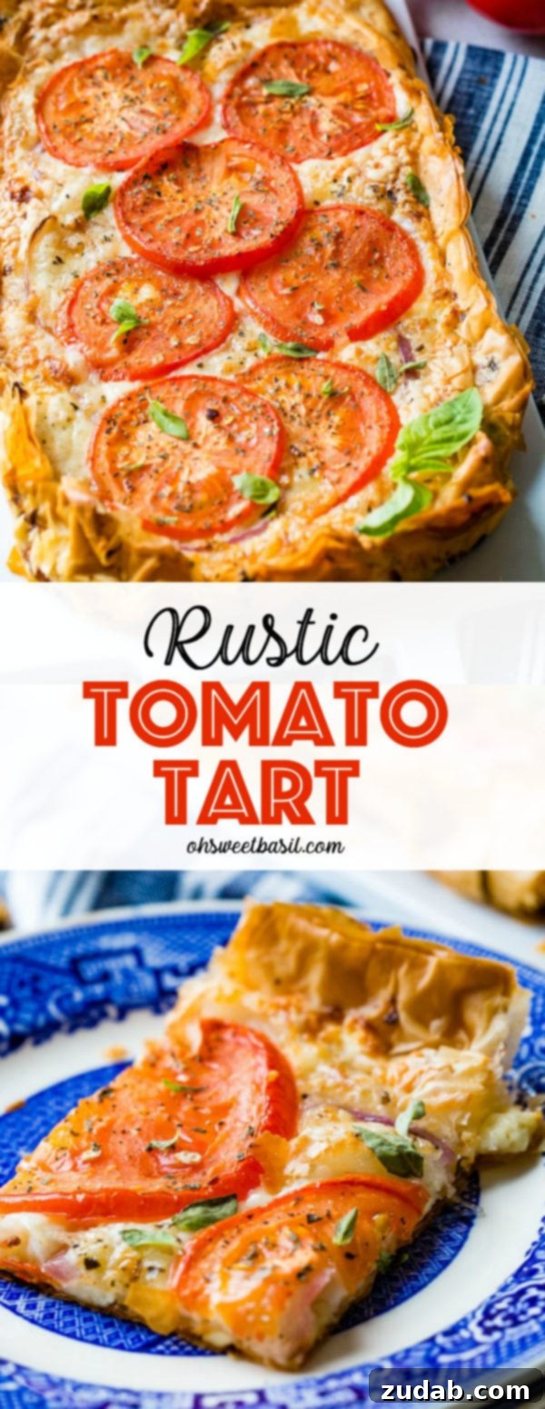 Country Tomato Galette 9 A close-up of a rustic tomato tart, generously adorned with fresh basil leaves, showcasing its inviting golden crust and the vibrant colors of its tomato and cheese filling.