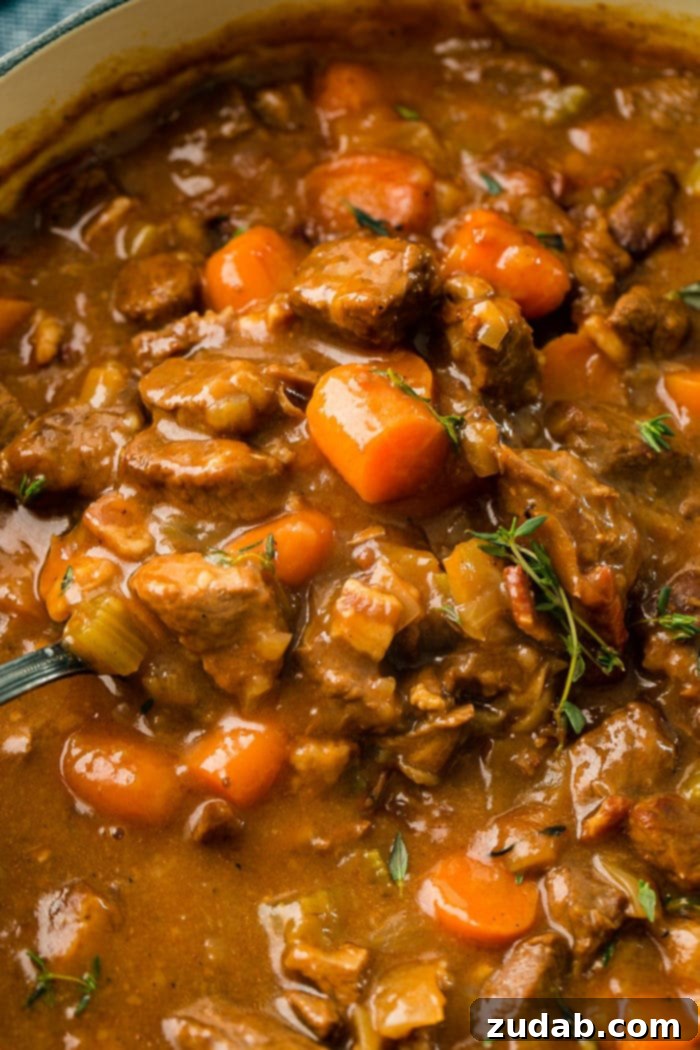 Hearty Irish Guinness Stew 2 A hearty bowl of Irish Beef Stew, featuring tender beef, vibrant carrots, and celery in a rich, savory gravy.