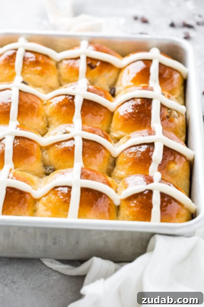 Pillowy Soft Hot Cross Buns 2 A photo of a silver cake pan of hot cross buns.